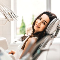 Woman sitting in dental chair during routine appointment.