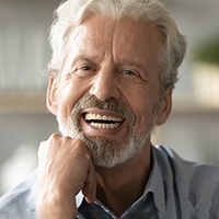 Older man with dentures smiling