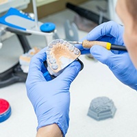 Dental lab technician working on dentures