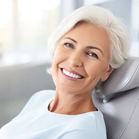 Smiling senior woman in dental treatment chair