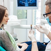 An older man admiring his new dental implants