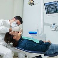 Doctor preparing patient for dental implant treatment