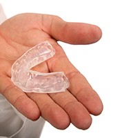 Dentist holding a custom-made mouthguard