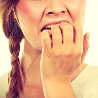 Woman biting her nails