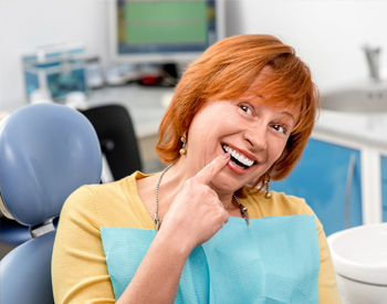 Senior woman pointing to beautiful smile