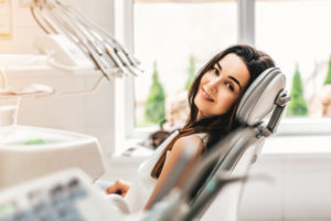 Happy dental patient in the dental chair