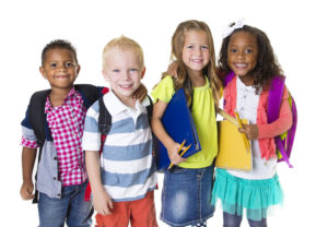 kids with backpacks smiling