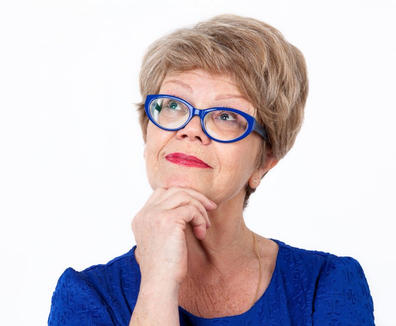 older woman blue glasses smiling