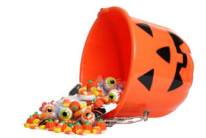 Halloween pumpkin bucket overflowing with candy