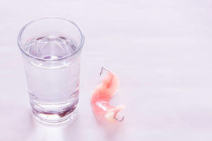 Partial denture and soaking solution
