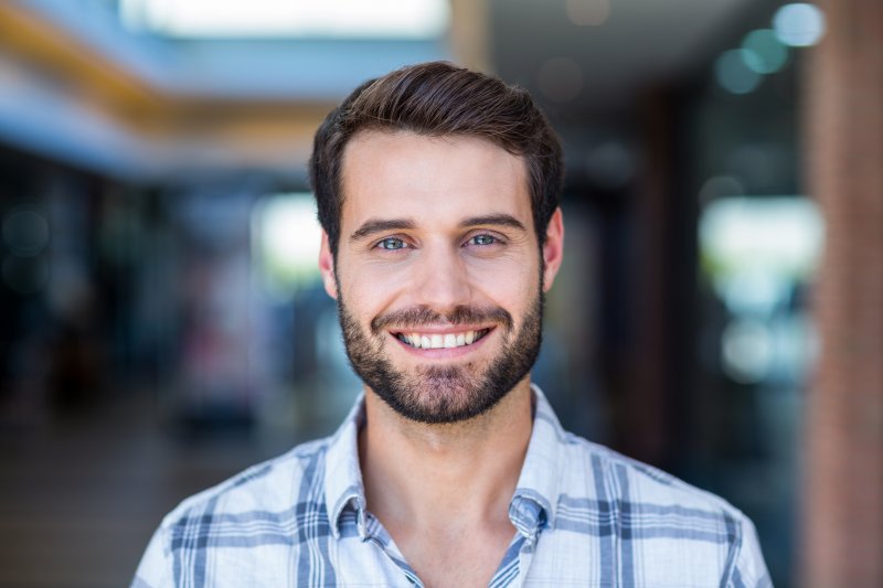 person smiling after receiving dental implants