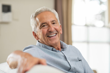 patient smiling after having ill-fitting dentures fixed