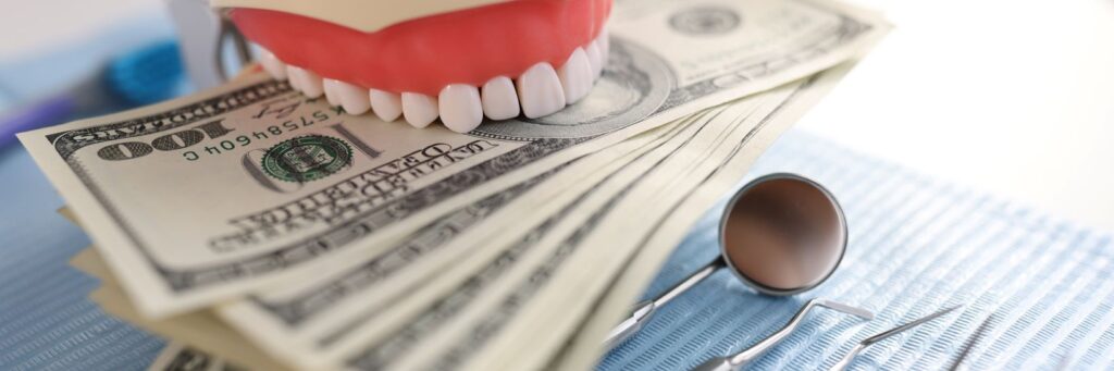 A model of teeth biting money